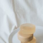 Stack of three clear soap bars on a white plate, embodying simplicity and cleanliness.